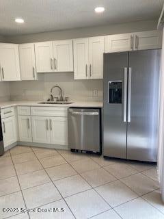 4612 Kaileen Circle Northeast Palm Bay, FL 32905 - Photo 7 of 8 a kitchen with stainless steel appliances granite countertop a refrigerator sink and cabinets