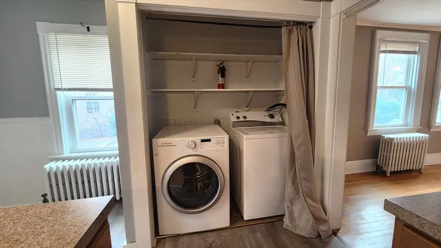 a view of a bedroom with washer and dryer