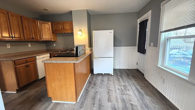 a room with wooden floor and cabinets
