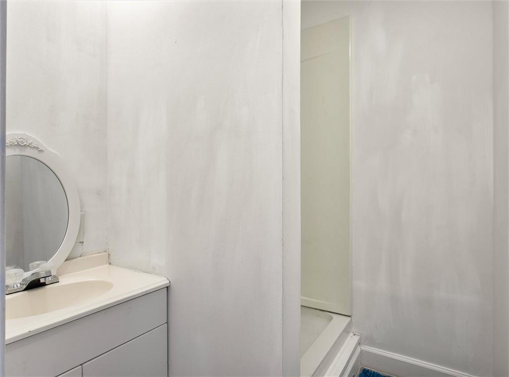 713 Deter Road Richmond, VA 23225 - Photo 14 of 25 First level half bath with shower and sink