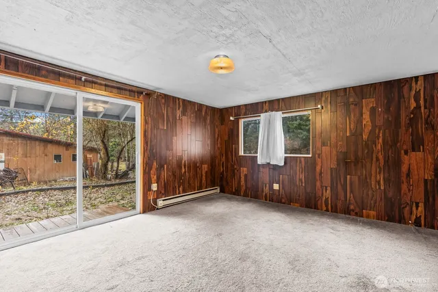 an empty room with sliding door and wooden floor