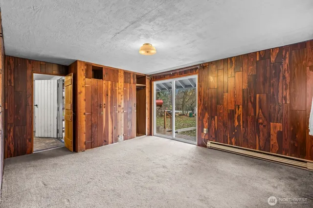 an empty room with sliding door and wooden floor