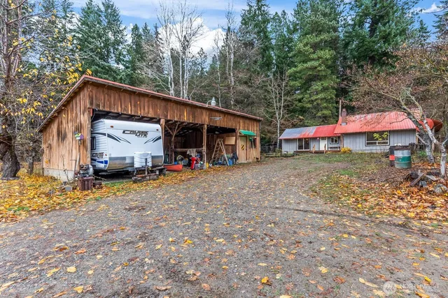a view of a house with a yard and sitting area