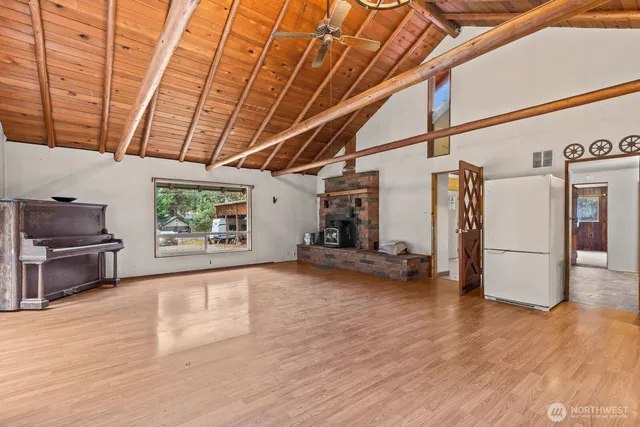 a view of a room with wooden floor and furniture