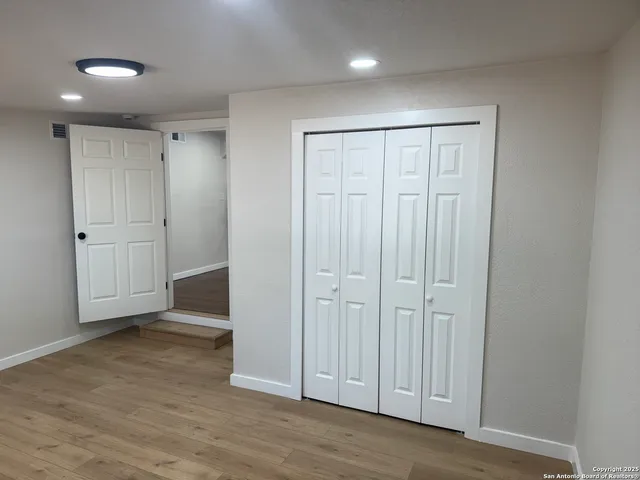 a bathroom with a sink vanity mirror and toilet