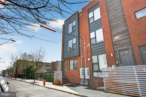 a front view of a residential apartment building with a yard