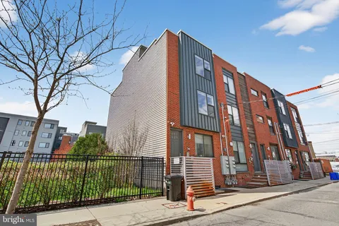 a view of a brick building next to a road