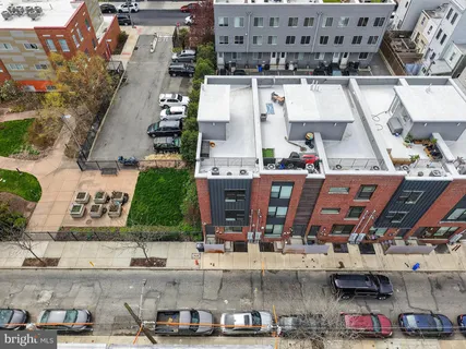 an aerial view of residential houses with outdoor space