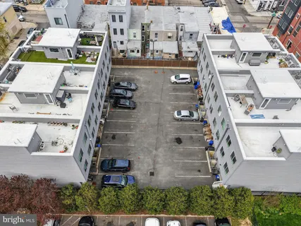 an aerial view of residential house with parking