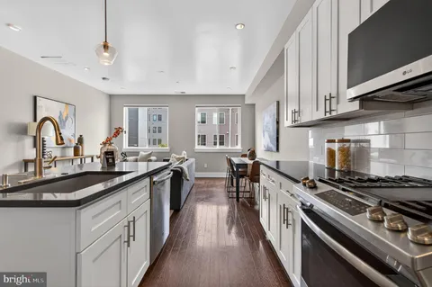 a kitchen with sink stove and cabinets