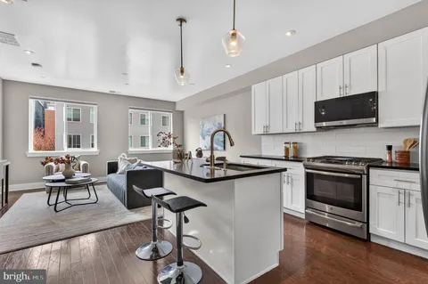 a kitchen with sink stove and cabinets