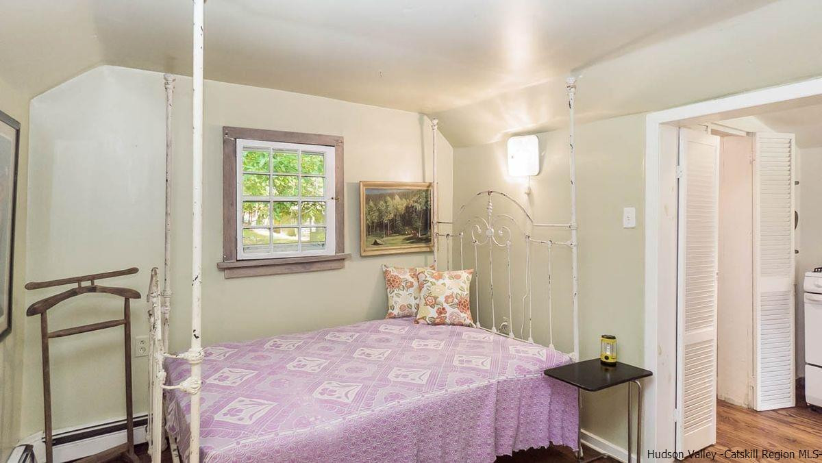 286 Rochester Center Road Kerhonkson, NY 12446 - Photo 26 of 34 a bedroom with a bed and a window