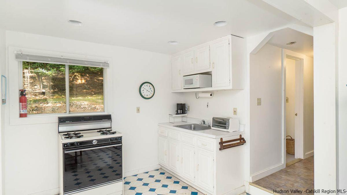 286 Rochester Center Road Kerhonkson, NY 12446 - Photo 30 of 34 a kitchen with a stove and a microwave