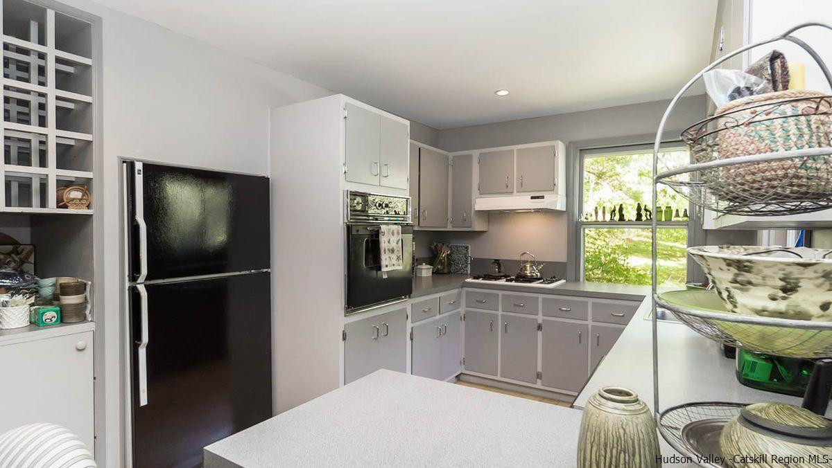 286 Rochester Center Road Kerhonkson, NY 12446 - Photo 7 of 34 a kitchen with stainless steel appliances a refrigerator a sink a stove a table and chairs