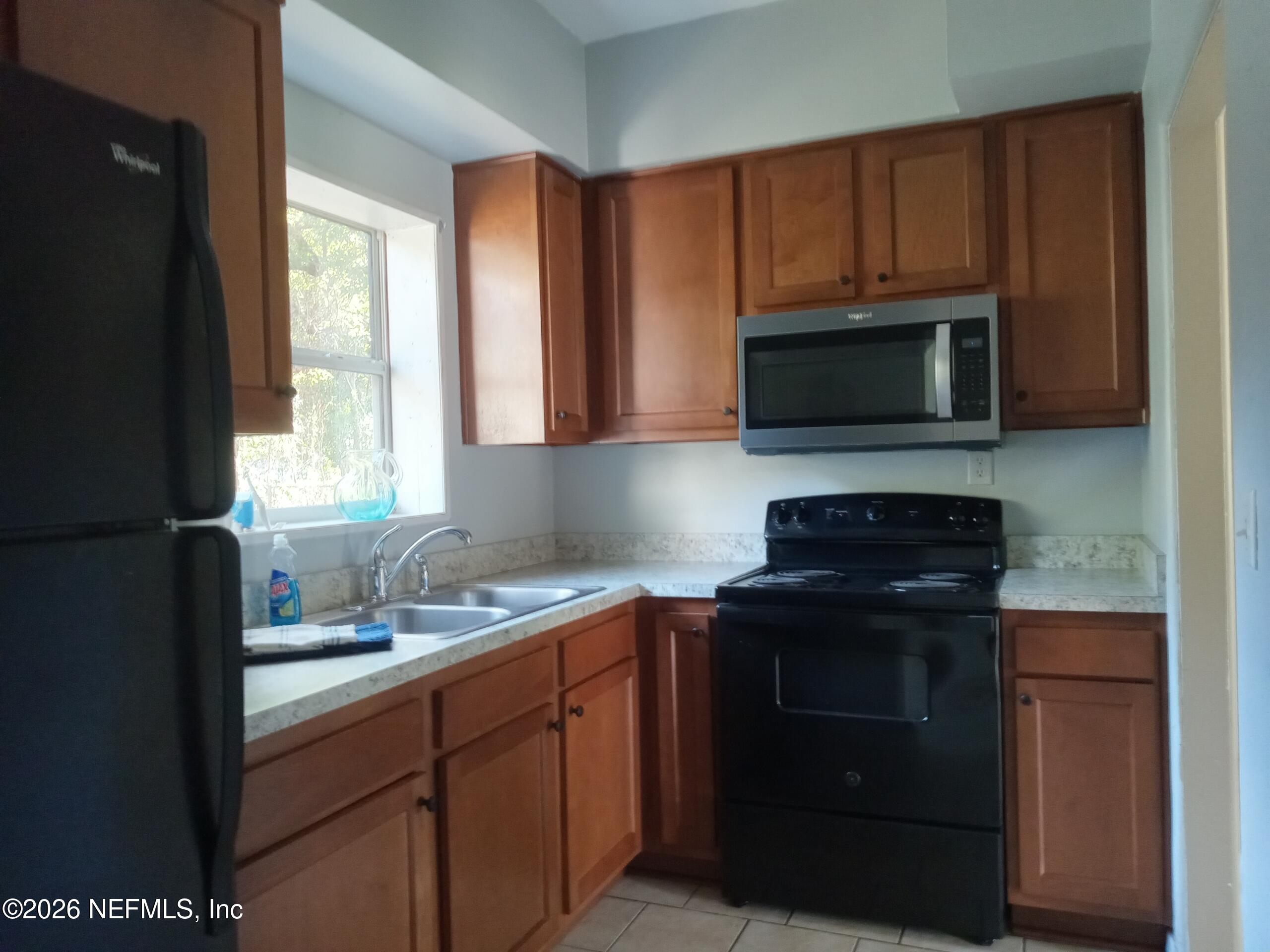 5527 Graywood Road Jacksonville, FL 32207 - Photo 5 of 12 a kitchen with a sink stove and microwave