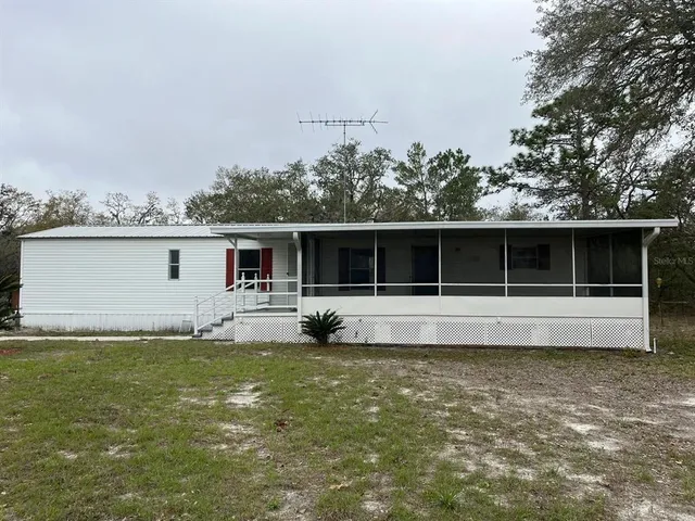 a view of house with backyard space and balcony