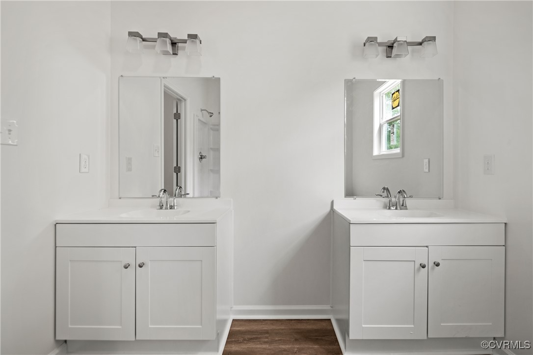 9214 River Road Petersburg, VA 23803 - Photo 30 of 36 Master bathroom featuring two vanities and wood fi