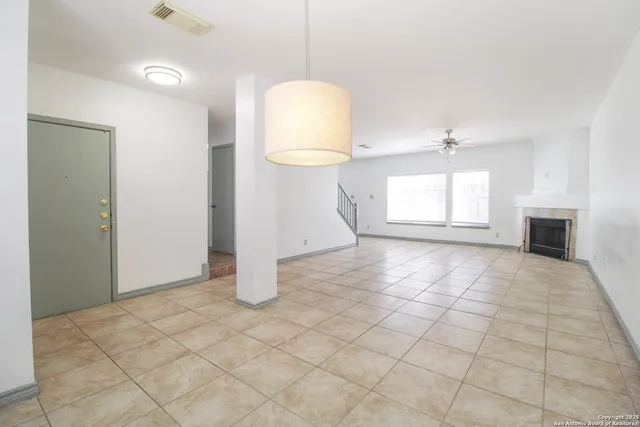 an empty room with windows and cabinet