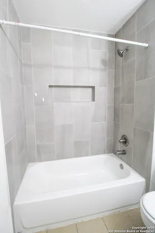 a bathroom with a toilet sink vanity and mirror