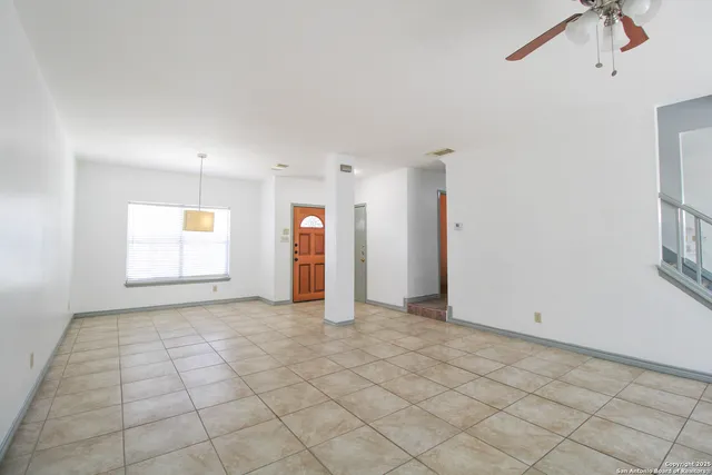 an empty room with windows and cabinet