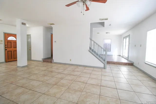 a view of an entryway with a chandelier fan