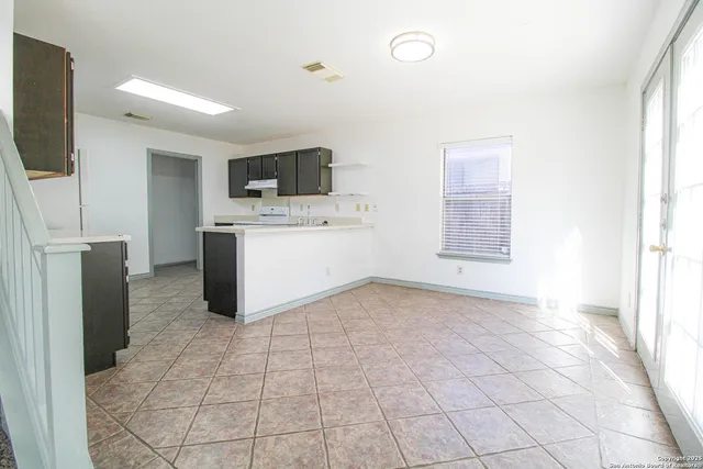 a view of a kitchen with a sink and a refrigerator