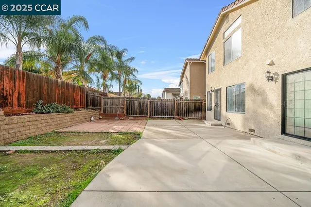 a view of backyard with swimming pool and seating