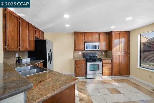 a kitchen with a refrigerator sink and stove