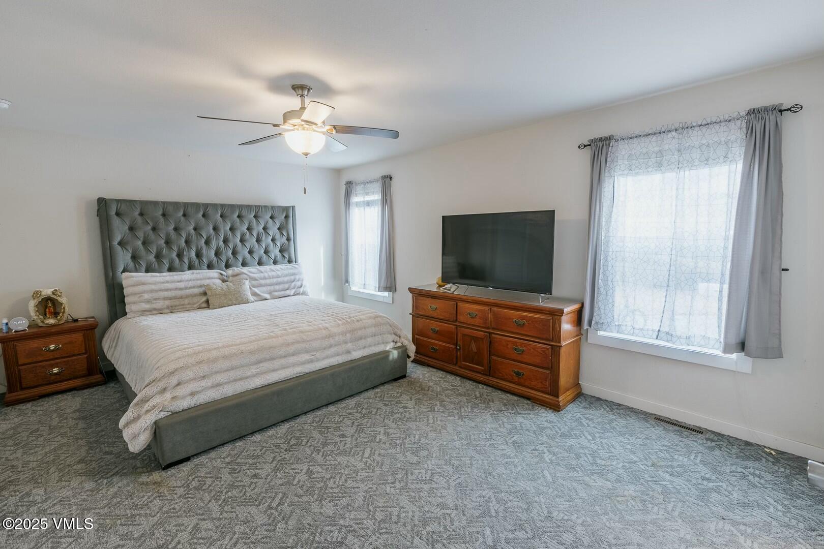 66 Bluegill Loop Gypsum, CO 81637 - Photo 15 of 37 a bedroom with a bed and a flat screen tv