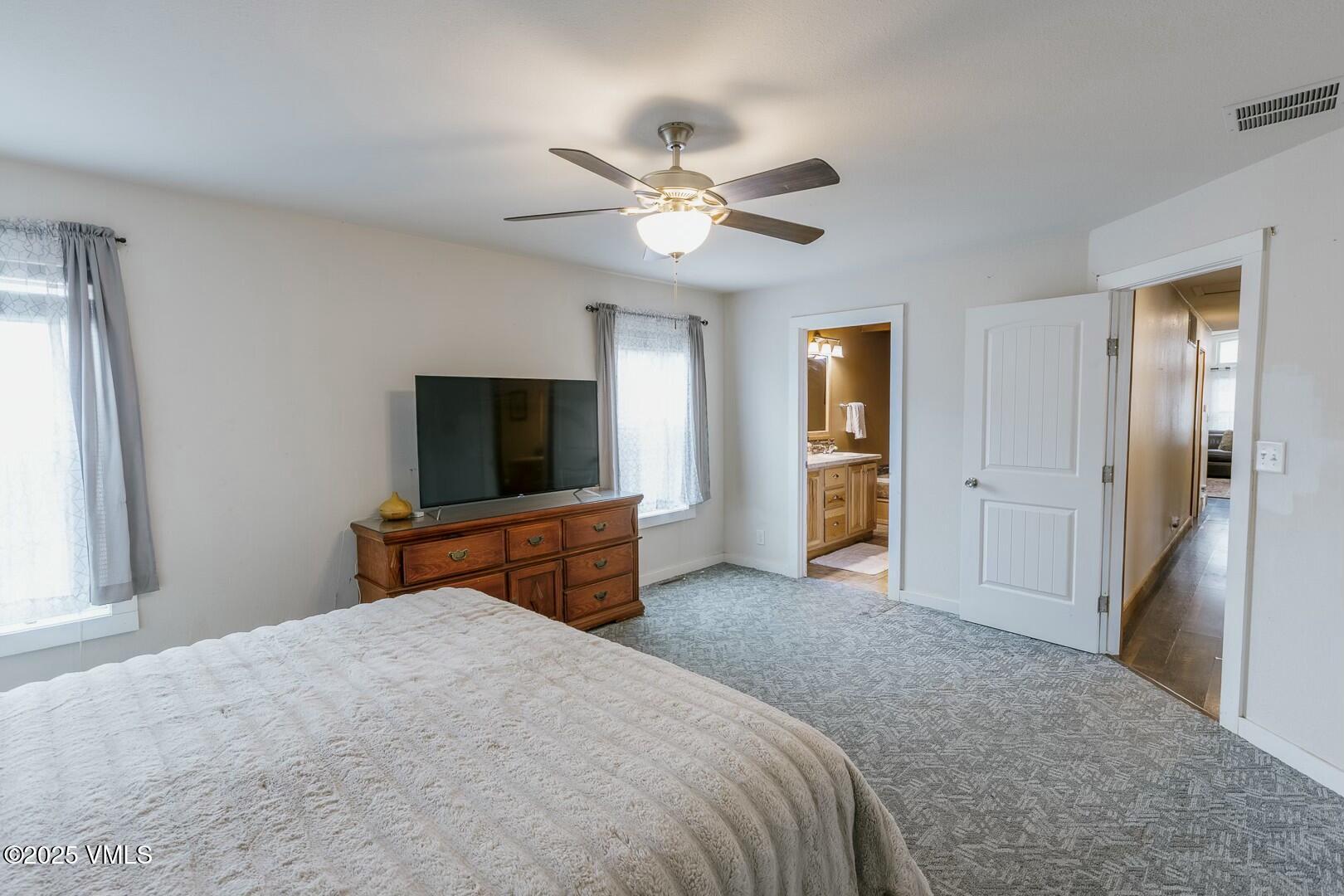 66 Bluegill Loop Gypsum, CO 81637 - Photo 17 of 37 a bedroom with a bed and a flat screen tv