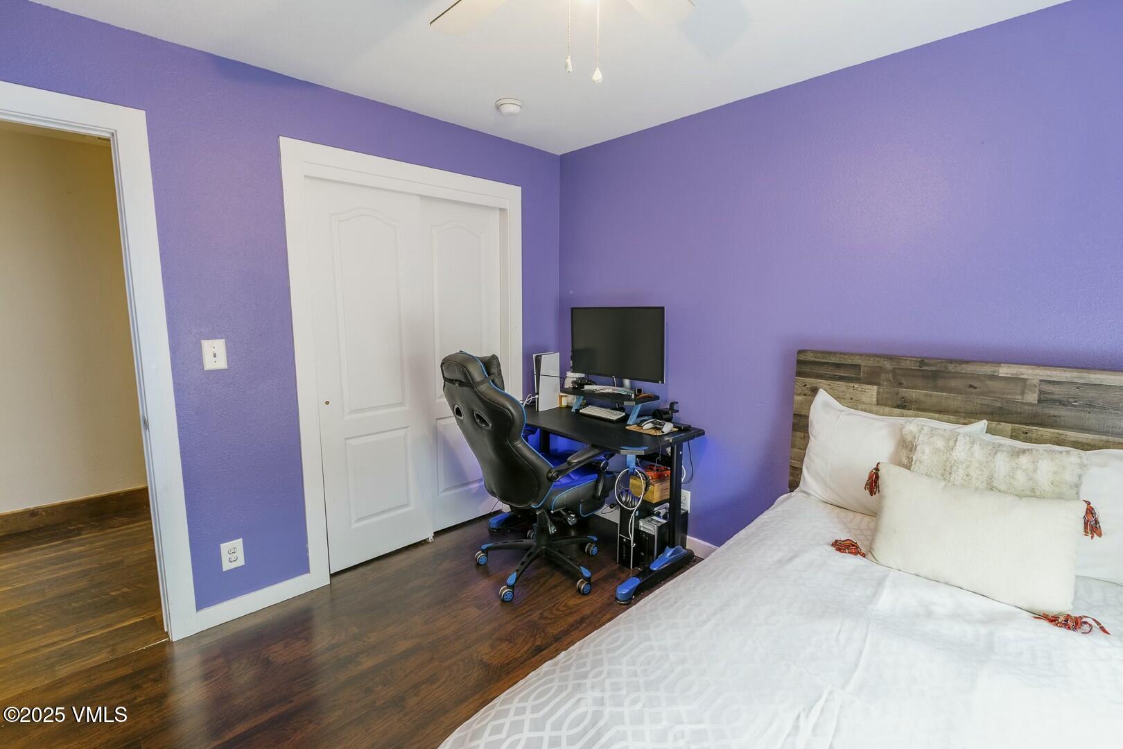 66 Bluegill Loop Gypsum, CO 81637 - Photo 23 of 37 a bedroom with a bed and wooden floor