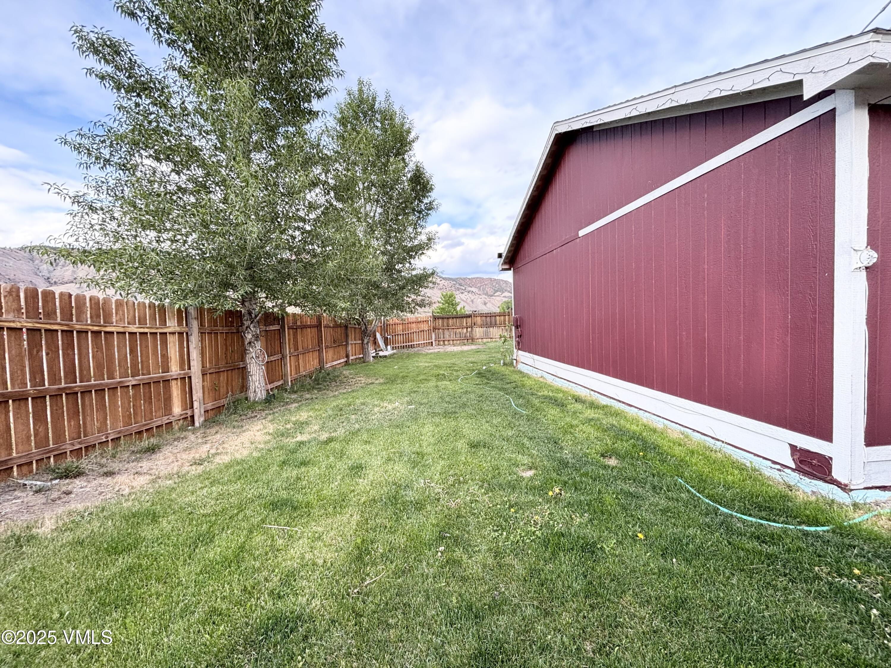 66 Bluegill Loop Gypsum, CO 81637 - Photo 28 of 37 a backyard of a house with grass and stairs