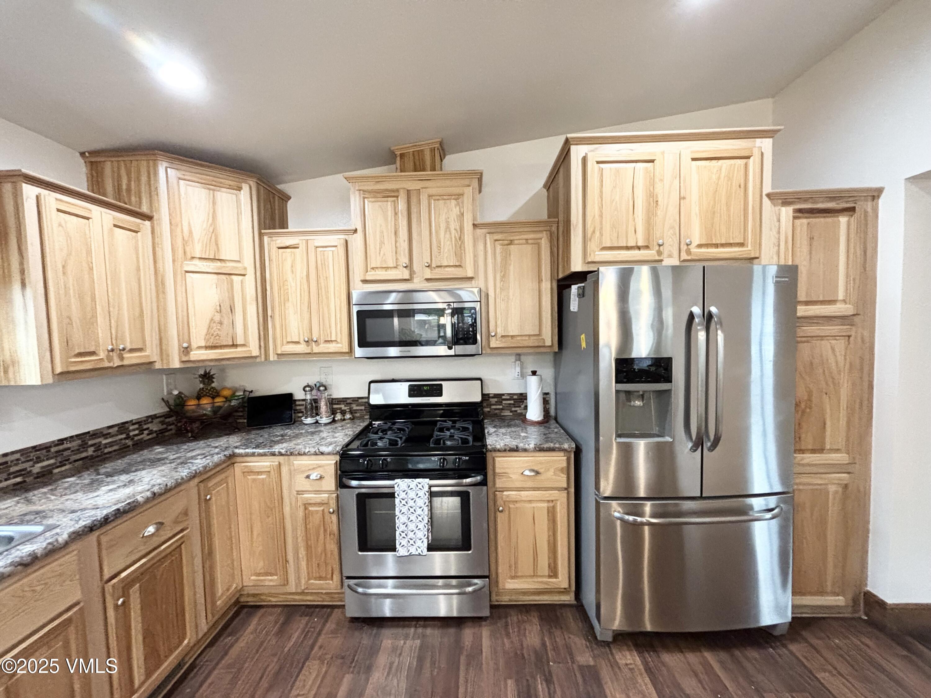 66 Bluegill Loop Gypsum, CO 81637 - Photo 9 of 37 a kitchen with stainless steel appliances a refrigerator sink and microwave