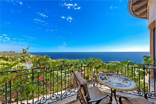 a view of a chairs and table in the balcony