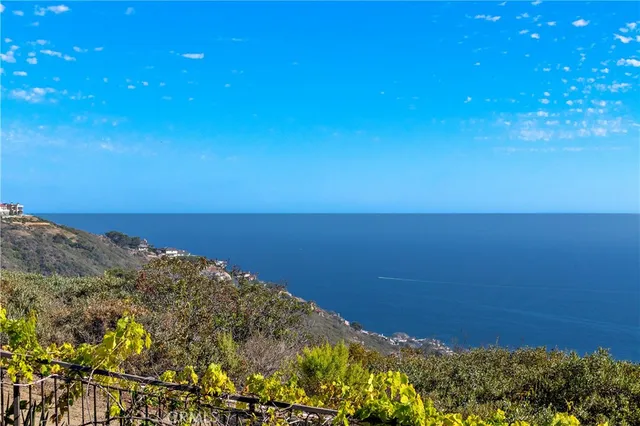 a living room with furniture large window and wooden floor
