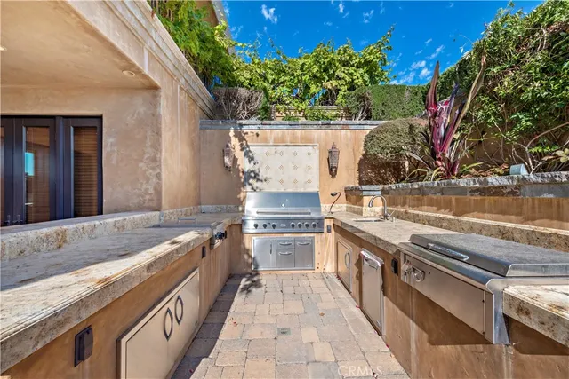 a kitchen with stainless steel appliances granite countertop a stove and a wooden cabinets