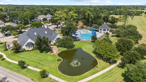 an aerial view of a house with a yard and lake view