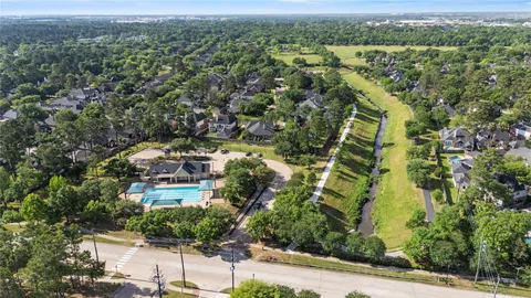 an aerial view of residential houses with outdoor space and street view