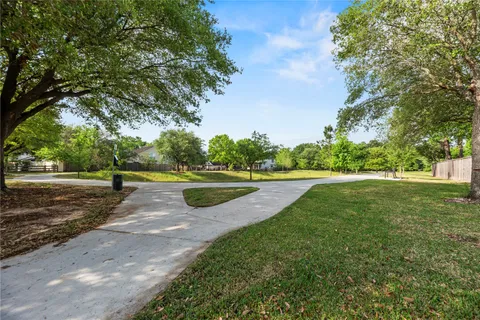 a view of a park with large trees