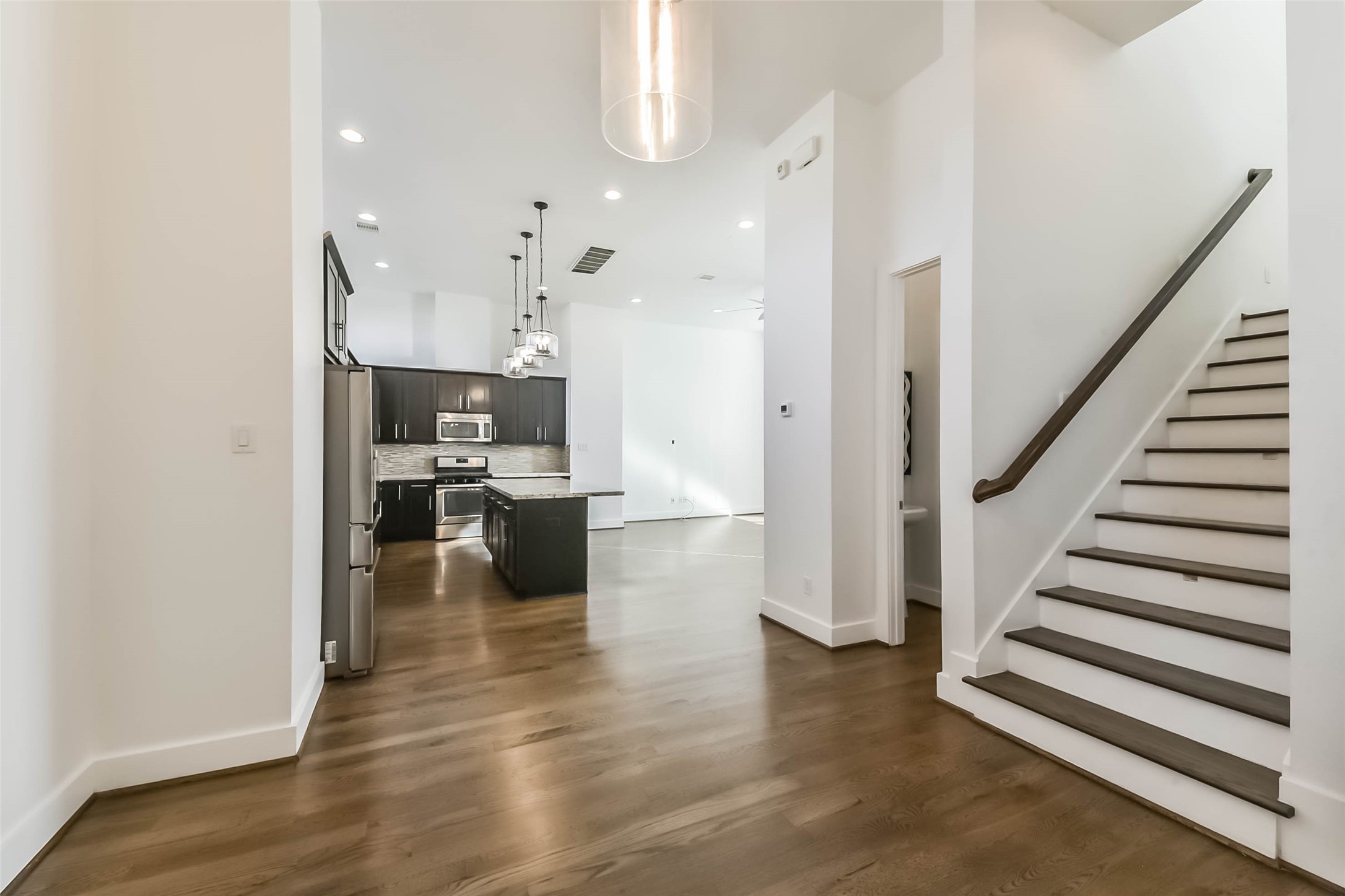 1810 Thompson Street Houston, TX 77007 - Photo 16 of 32 a view of a kitchen with refrigerator and wooden floor