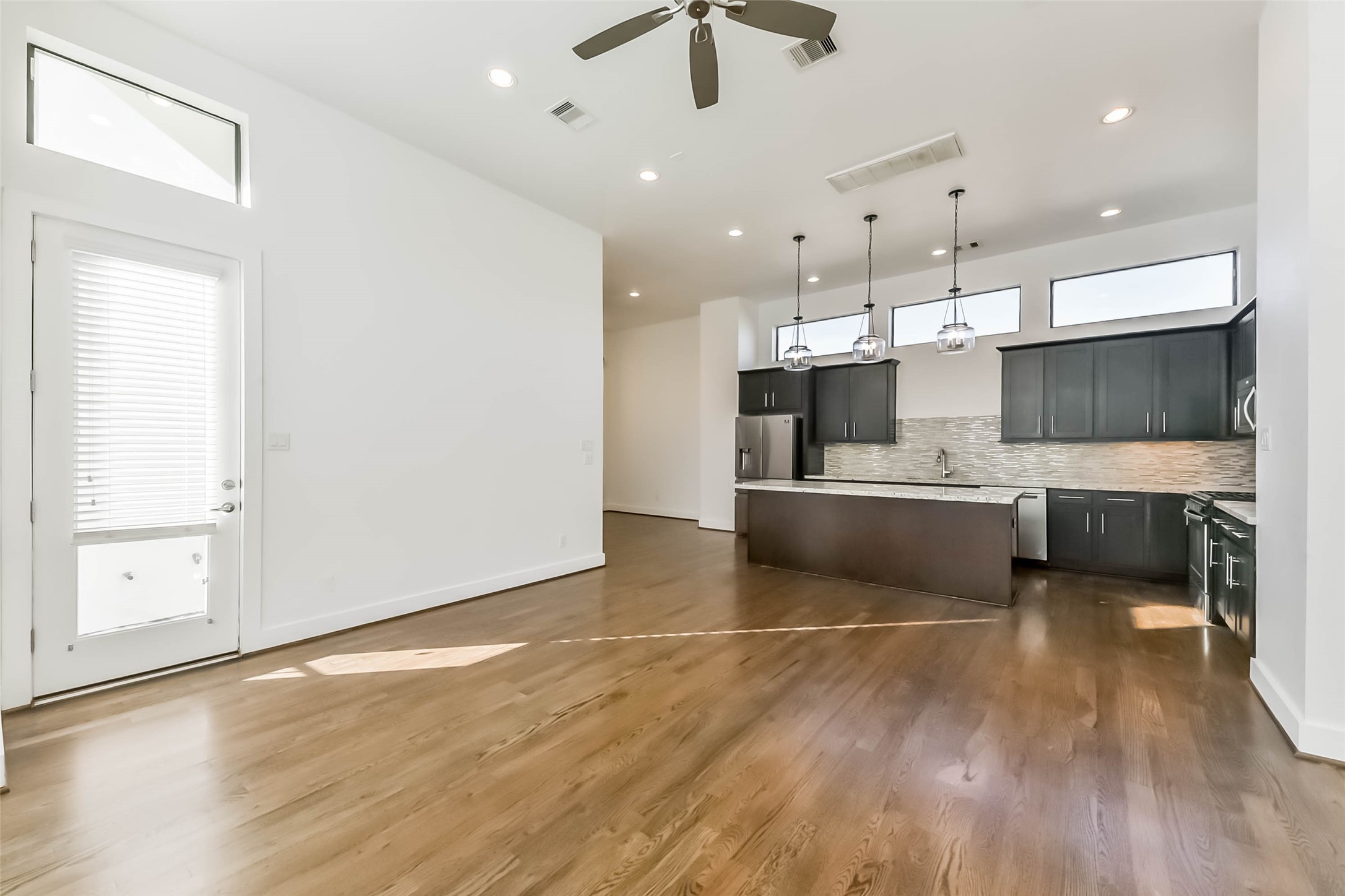 1810 Thompson Street Houston, TX 77007 - Photo 7 of 32 a large white kitchen with a sink dishwasher a stove and a microwave oven with cabinets