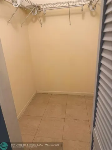 a bathroom with a granite countertop toilet a sink and a mirror