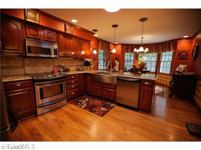 5401 Edgerunner Road Oak Ridge, NC 27310 - Photo 2 of 16 Kitchen. Well equipped kitchen with granite counters, stainless steel appliances, pantry and gorgeous cabinetry.