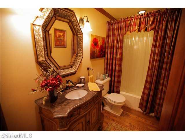 5401 Edgerunner Road Oak Ridge, NC 27310 - Photo 13 of 16 Other Bath. The guest bath is warm and welcoming.