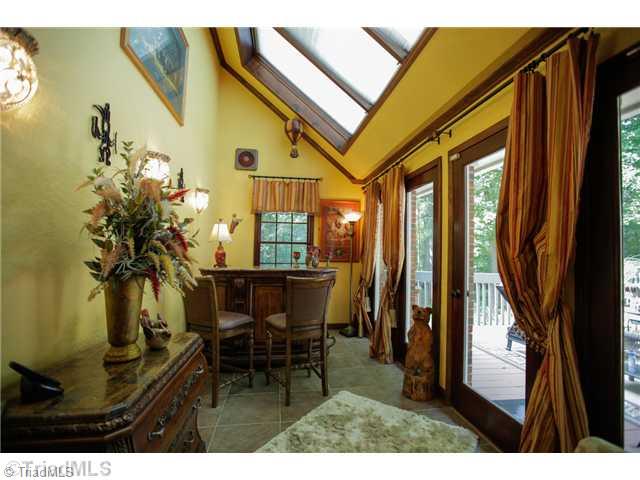 5401 Edgerunner Road Oak Ridge, NC 27310 - Photo 15 of 16 Sunroom. This charming room with tile floor, vaulted ceiling and wall of windows leads outside to massive deck and multiple outdoor living spaces.