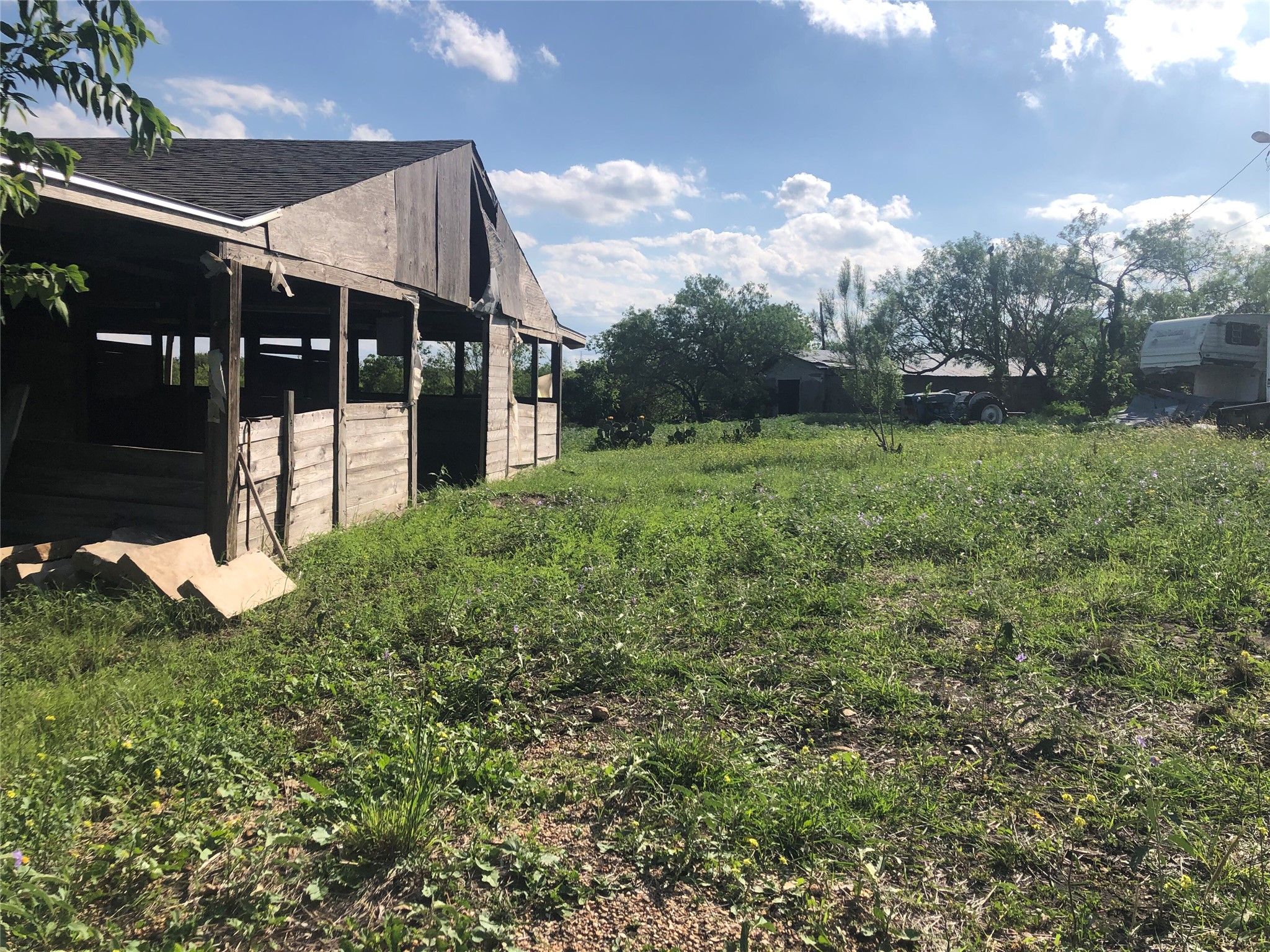13414 Elm Grove Road Buda, TX 78610 - Photo 4 of 13 A rustic barn and verdant grounds define this spacious rural setting, awaiting your vision.