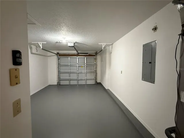 a view of room that has a white car parked