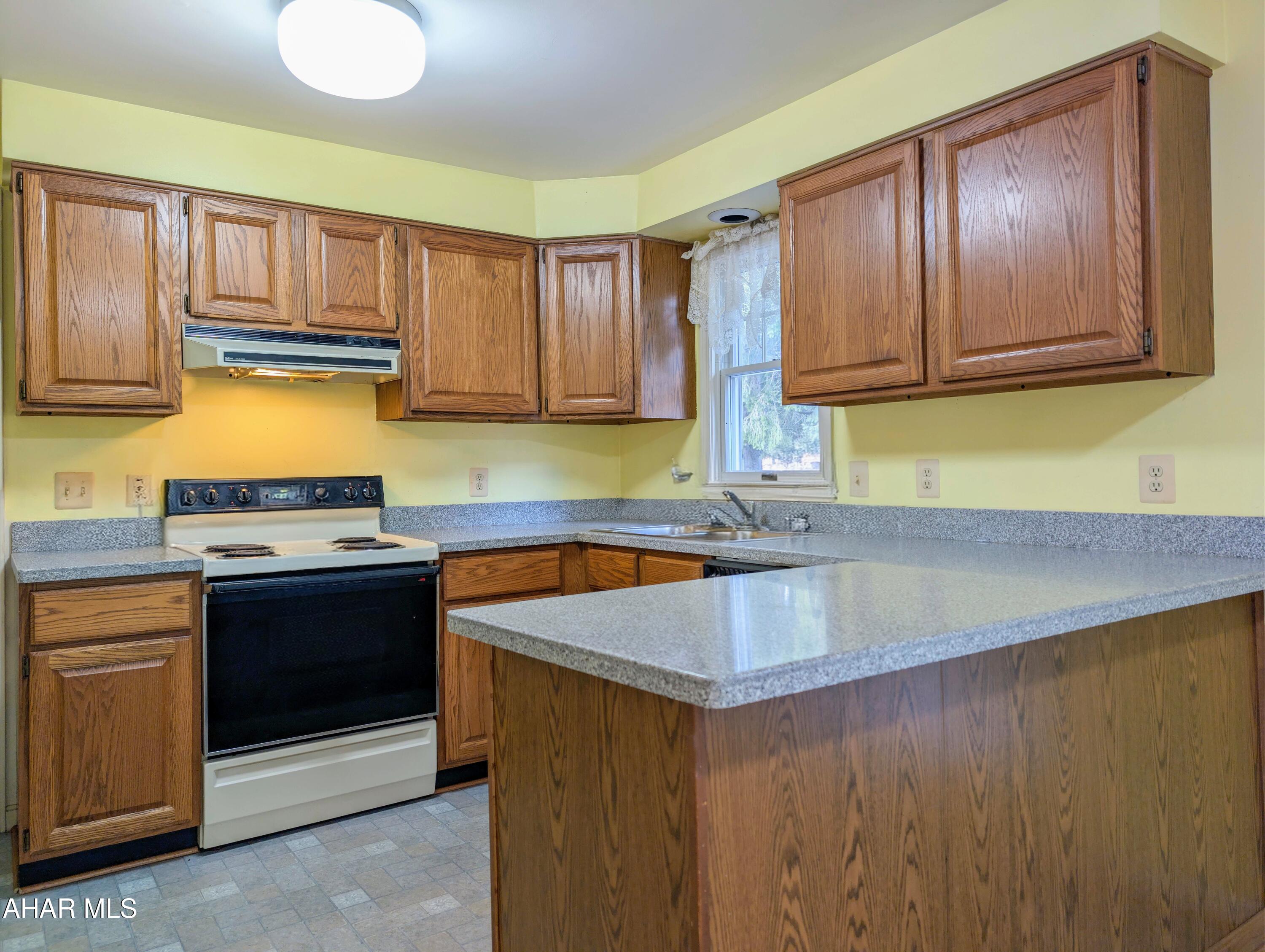 147 Pine Street Hyndman, PA 15545 - Photo 8 of 44 a kitchen with granite countertop a stove and a sink