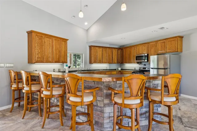 a dining table chairs and chandelier in a room
