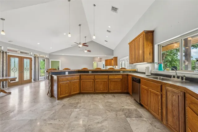 a large kitchen with a large window and stainless steel appliances